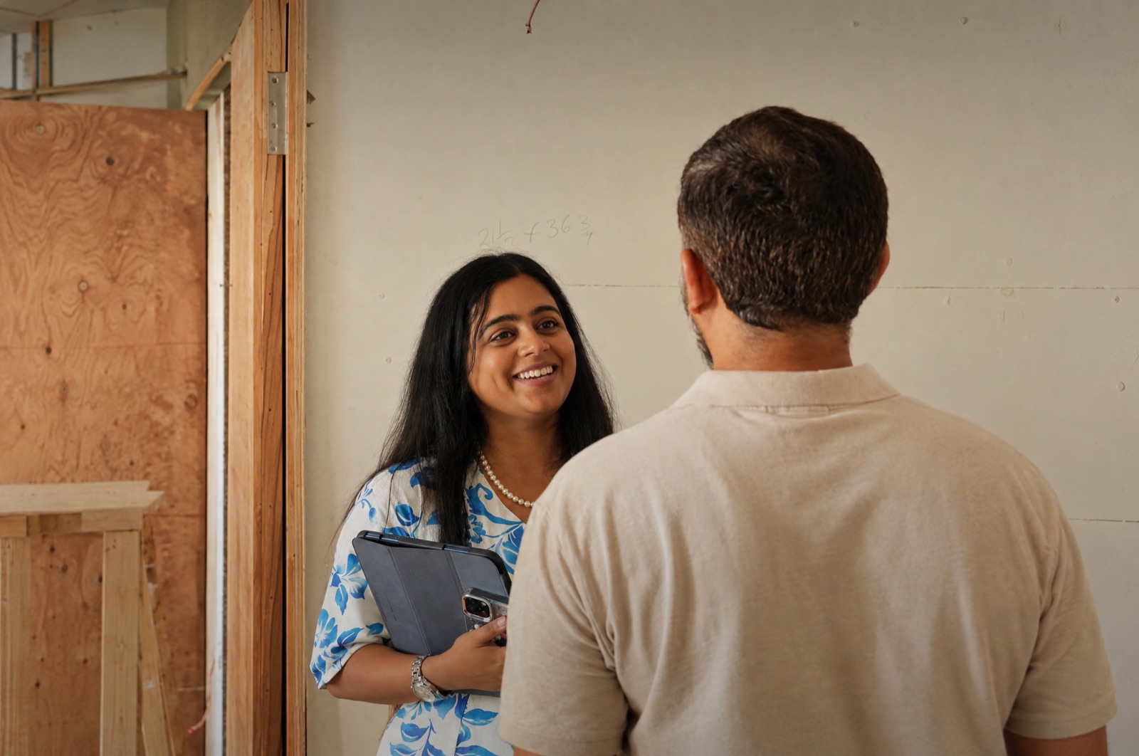 Surbhi talking with a contractor on a raw site
